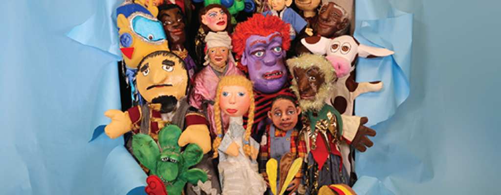 a collection of Literature Live puppets busting through a blue paper