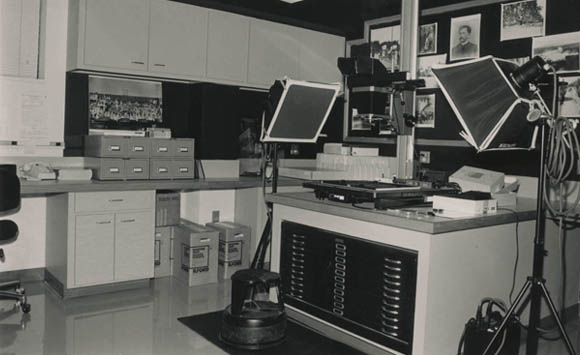 Black and white photograph of the Austin History Center Photo Lab, showing a 4-by-5 copy stand system.