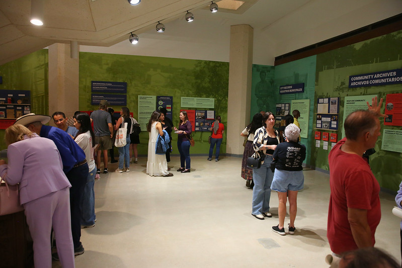 Image shows attendees at opening of Unboxing Archive Exhibit