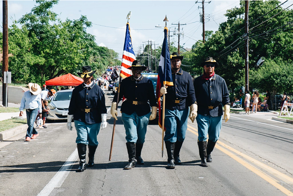 Four Buffalo Soldiers in Uniform walking in parade in Austin