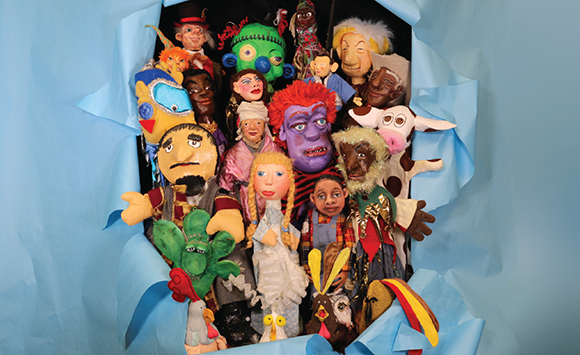 a collection of Literature Live puppets busting through a blue paper