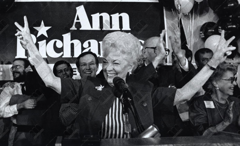 Ann Richards in front of a microphone