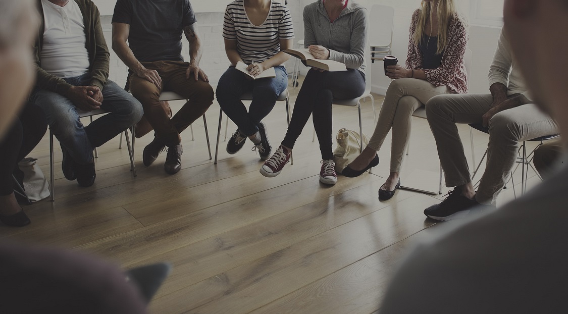 Group of people sitting in a semi-circle