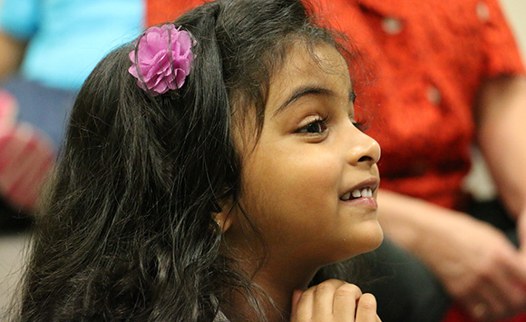 Young girl in a audience smiling