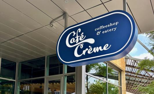 Cafe Creme sign in front of the Central Austin Public Library downtown