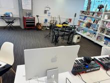 guitars, keyboards, drum set in music lab
