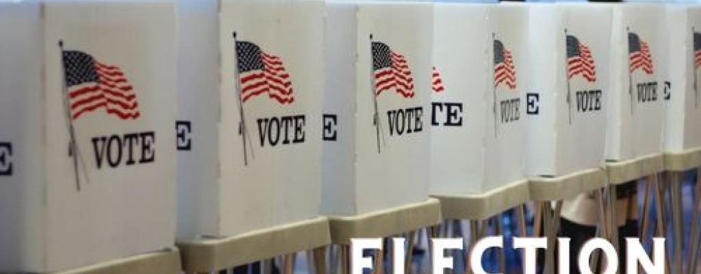 voting booths with american flags. Text that reads Election 2022.