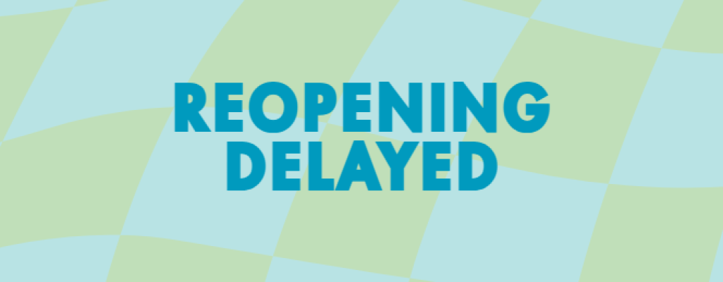 blue and green checked background with blue letters reading "REOPENING DELAYED"