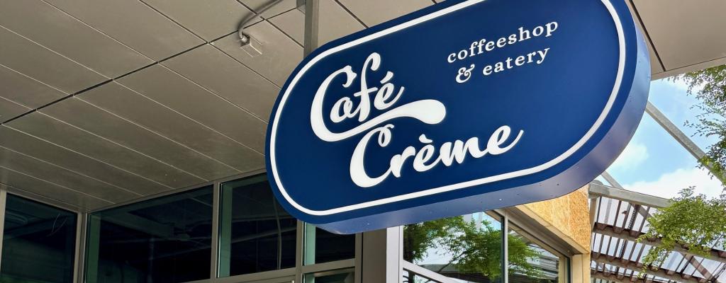 Cafe Creme sign in front of the Central Austin Public Library downtown
