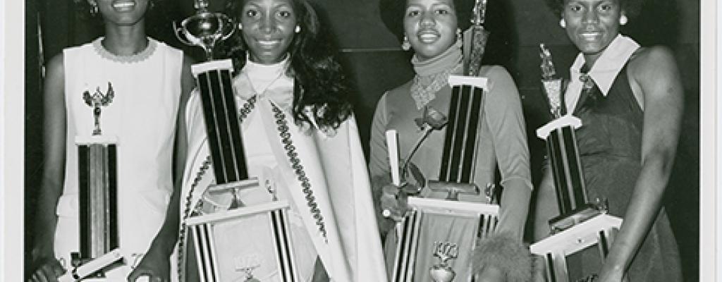 African American women holding trophies