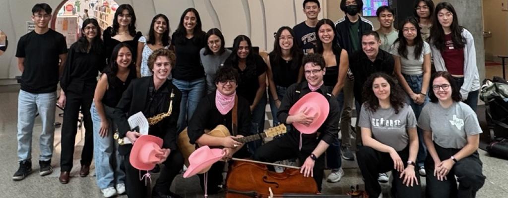 musicians huddles together for photo in front of children's room