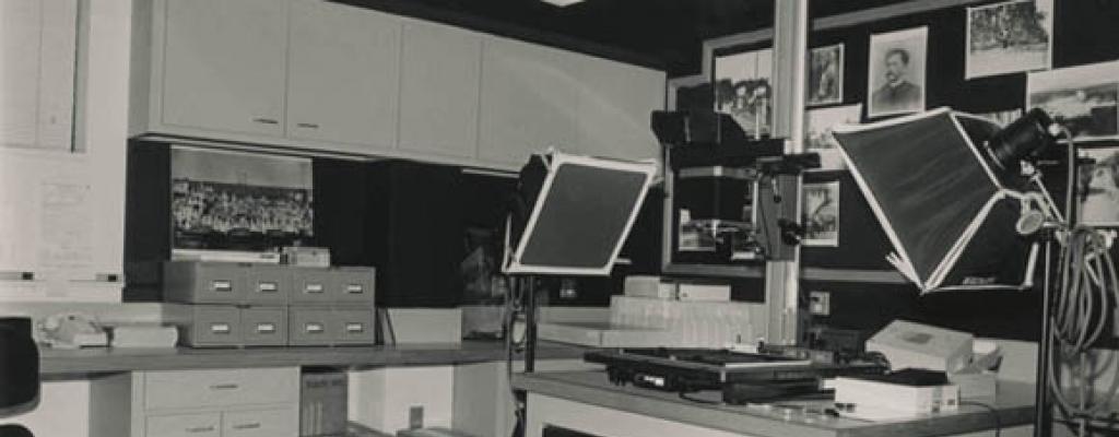 Black and white photograph of the Austin History Center Photo Lab, showing a 4-by-5 copy stand system.