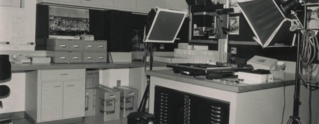 Black and white photograph of the Austin History Center Photo Lab, showing a 4-by-5 copy stand system.