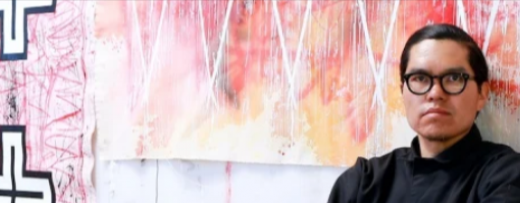 Artist Patrick Dean Hubbell in front of one of his art pieces