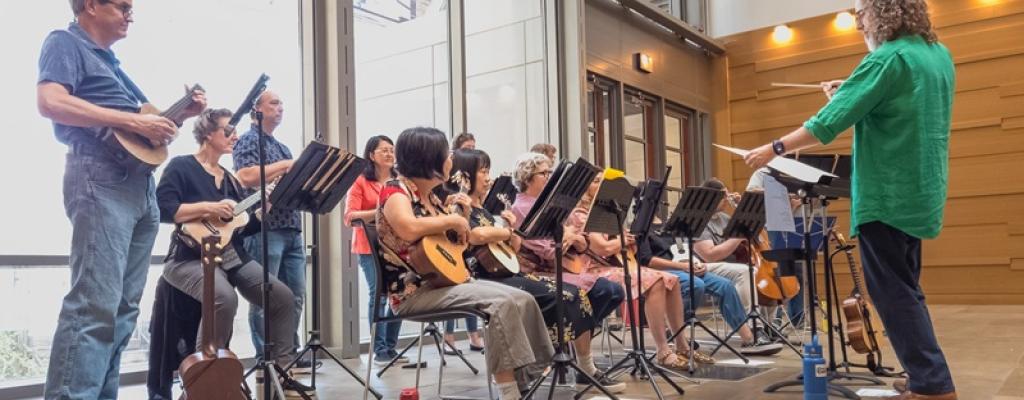 ukulele musicians seated for a performance
