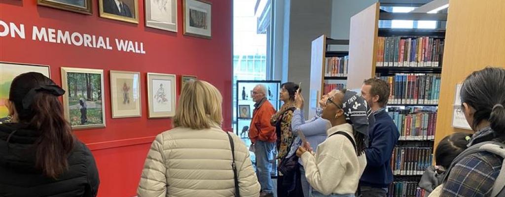 people gathered around viewing art