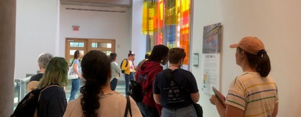 people gathered around viewing art