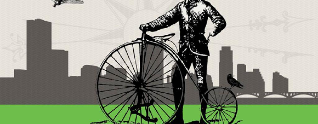 old timey bike with man holding it