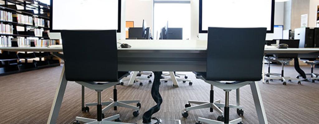 Table with two computers and two chairs