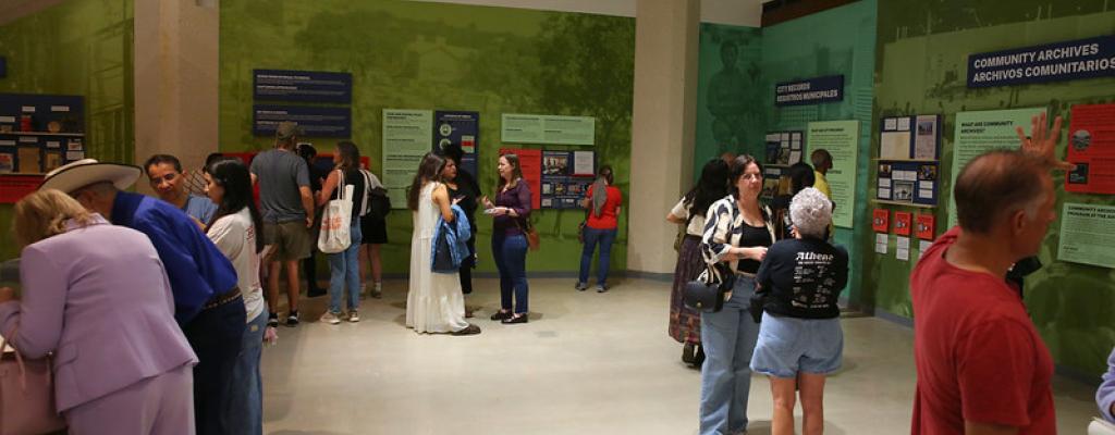 Image shows attendees at opening of Unboxing Archive Exhibit