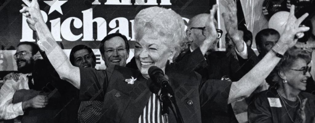 Ann Richards in front of a microphone