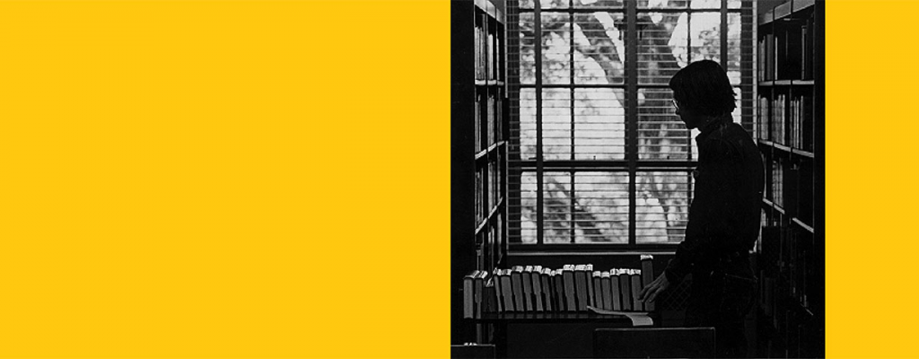 Person with book card in the library